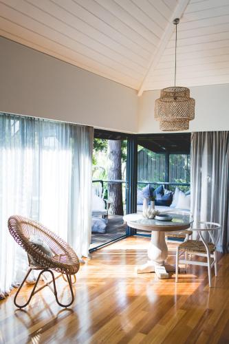a dining room with a table and two chairs at Empire Spa Retreat in Dunsborough