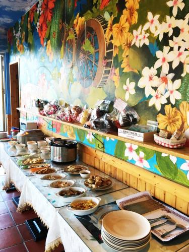 a buffet line with plates of food on it at Rainbow Bridge B&B in Sanzhi