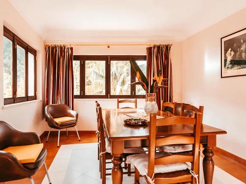 a dining room with a table and chairs at Oliveira's House By Gt House in Sintra