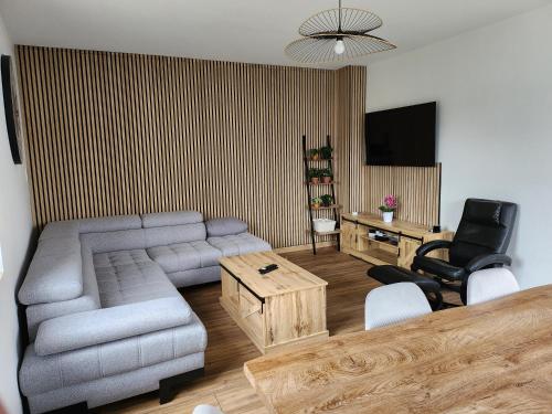 a living room with a couch and a table at Cocon in Domérat
