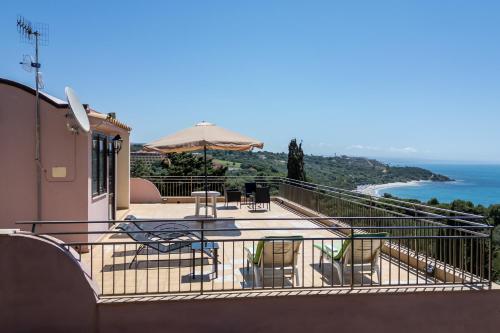 a balcony with a table and chairs and the ocean at Villa Rosa sul mare in Sciacca