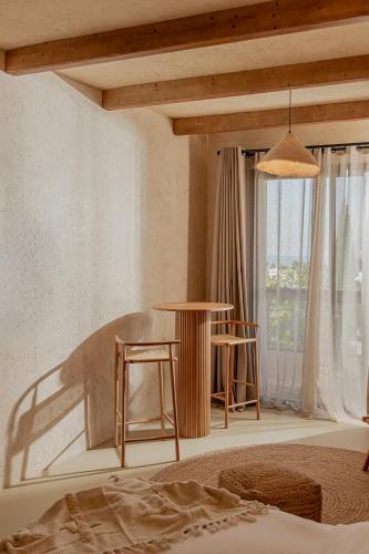 a bedroom with a bed and a table and chairs at Serab Residencia, Boutique Hotel & Resort in Al Kaslīk