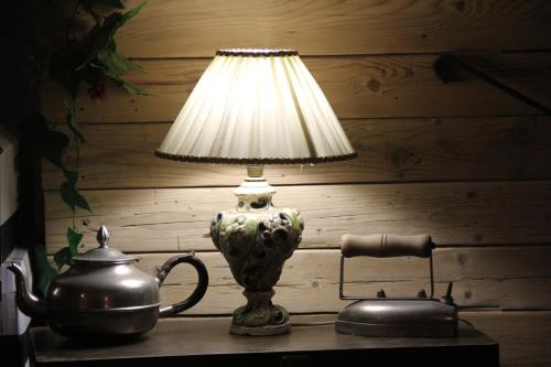 a lamp on a table next to a tea kettle at Paros Blue Dolphin FULLY RENOVATED by RIVEA GROUP in Chrissi Akti