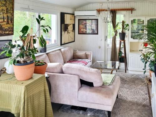 a living room with a couch and a table at 4 person holiday home in ÅRSTA HAVSBAD in Årsta Havsbad