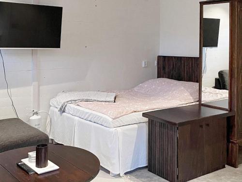 a bedroom with a bed with a mirror and a table at 3 person holiday home in UDDEVALLA-By Traum in Uddevalla
