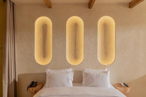 a bedroom with two lights hanging above a bed at Serab Residencia, Boutique Hotel & Resort in Al Kaslīk