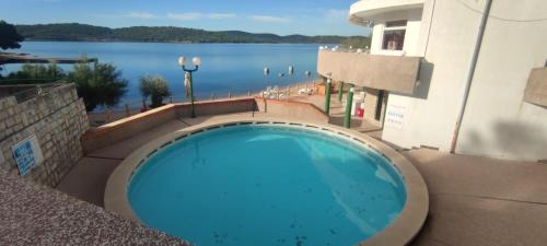 a large blue swimming pool on the side of a building at Mobile home Pirovac in Pirovac