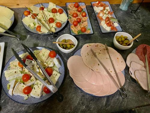 a table topped with plates of food and appetizers at Altstadt-Hotel Gosequell in Goslar
