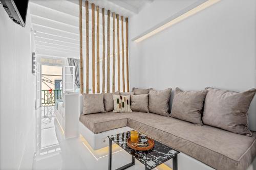 a living room with a couch and a table at Heart of Mykonos Suites in Mýkonos City
