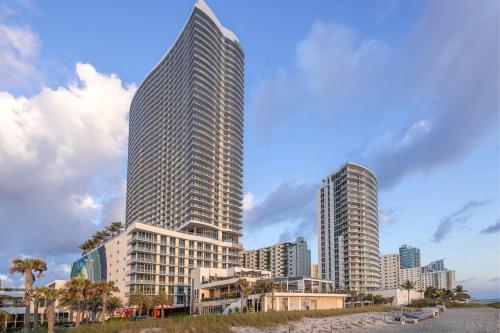 two tall skyscrapers in a city with buildings at Stunning Beachfront 3-Bedroom Corner Residence in Hollywood