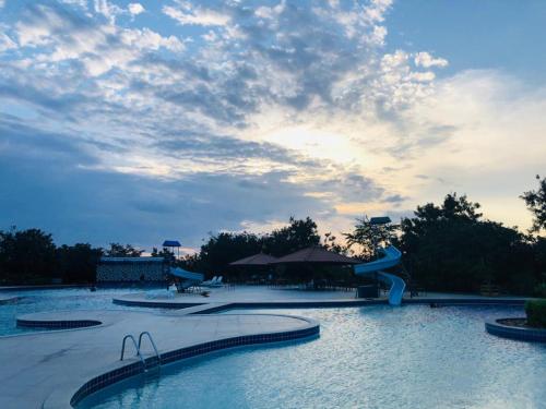 a swimming pool with a slide in a resort at HOTEL CANARIUS DE GRAVATA - Flat in Gravatá
