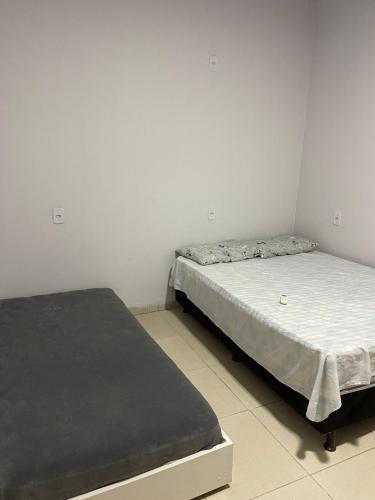 two twin beds in a room withthritisthritisthritisthritisthritisthritisthritisthritisthritis at Chácara Recreio 3 in Barra do Garças