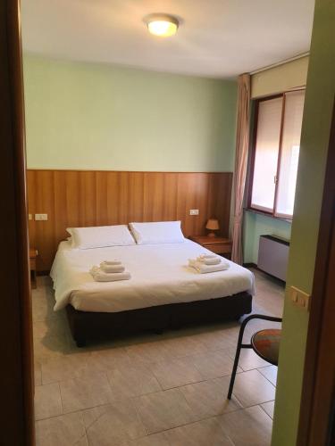 a bedroom with a bed with two towels on it at Casa ATENA in Villa dʼAlmè