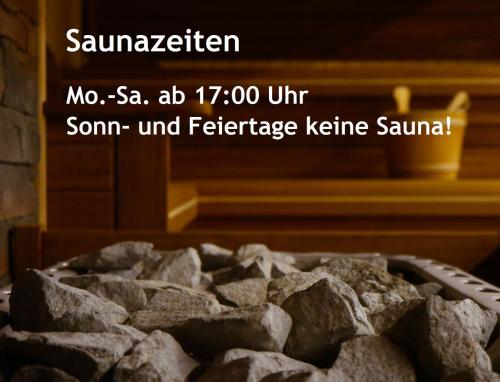 a bowl of rocks in front of a fireplace at Helle FeWo am Waldrand - mit Balkon, Pool & Sauna in Freyung