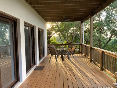 a wooden deck with a table and chairs on it at Apartment Diamond Hill Resort in Diamond Rock