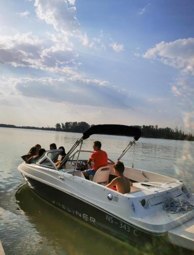 a group of people in a boat on the water at Vila Fina in Čerević