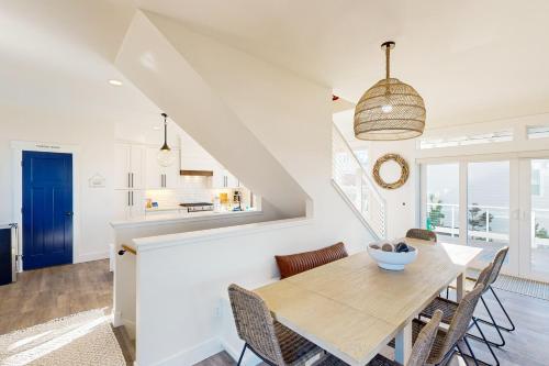 a kitchen and dining room with a wooden table and chairs at Off of the Hook in Lincoln City