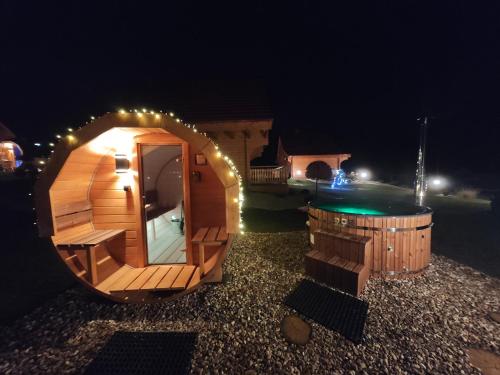 a small wooden cabin with a pool at night at Górskie Wytchnienie Domki Karkonosze in Piechowice