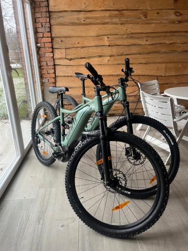 a green bike parked in a room next to a window at Polana Gorska in Jelenia Góra