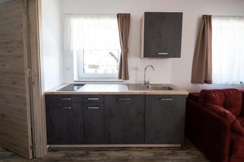 a kitchen with a sink and a window at Hiša Janko Bled in Bled