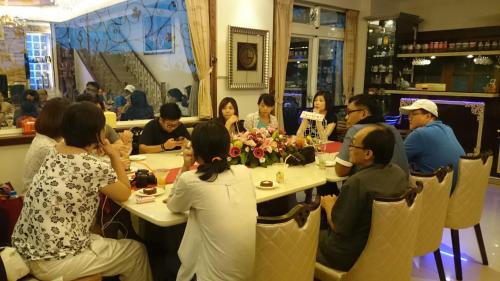 a group of people sitting around a table at Mandy's House B&B in Shangwu