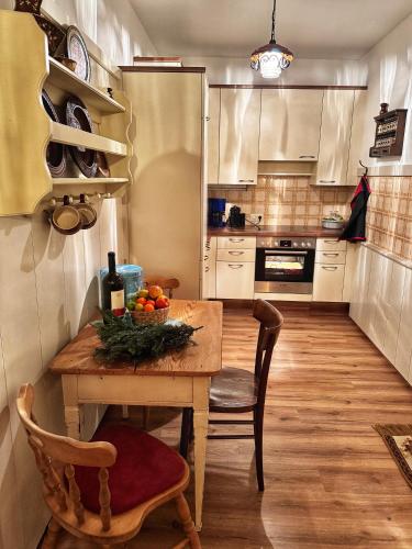 a kitchen with a wooden table with a bowl of fruit on it at Koralm Appartement 7 in Wolfsberg