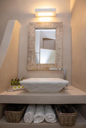 a bathroom with a large white tub and a mirror at KVilla Comfort Living in Triandáros