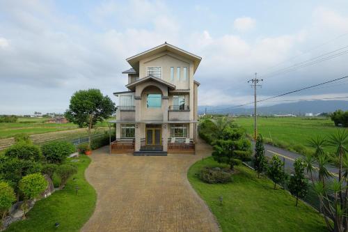 a large house on a street with a driveway at Mandy's House B&B in Shangwu