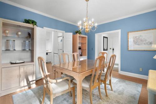 a dining room with a wooden table and chairs at Pawleys Plantation Retreat Villa Deluxe Amenities in Pawleys Island