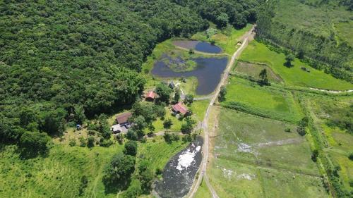 an aerial view of a house and a river at Hostel Serramar in Palhoça