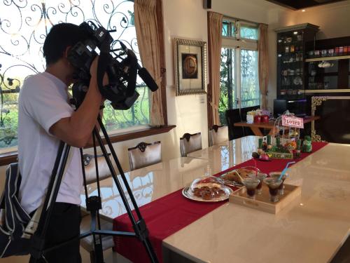 a man taking a picture of a counter with a camera at Mandy's House B&B in Shangwu