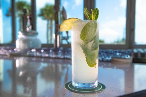 a drink with a lime and mint on a table at Holiday Inn Resort Jekyll Island by IHG in Jekyll Island