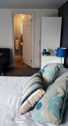 a bed with two pillows and a lamp on it at The Greyhound, Hackforth Near Bedale in Hackforth