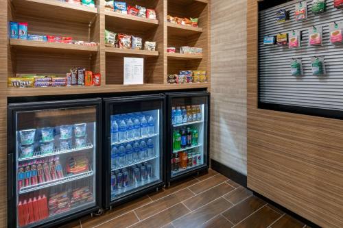 a grocery store aisle with two refrigerators and drinks at TownePlace by Marriott Suites Gallup in Gallup