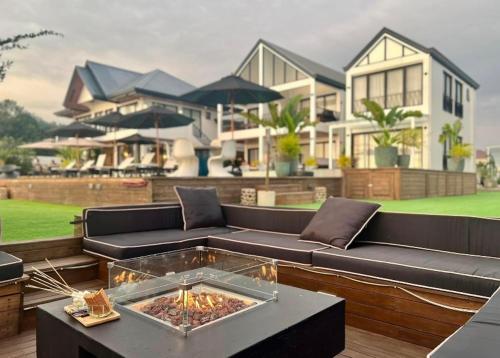 a living room with a couch and a house at Natalna Boutique Home in Bacnotan