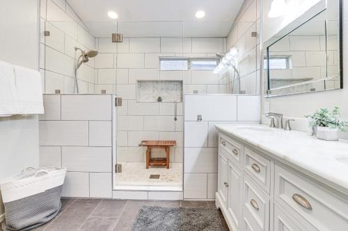 a white bathroom with a shower and a sink at Desert Oasis with Outdoor Living in Goodyear! in Liberty