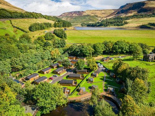 an aerial view of a village in the hills at Dovestone Luxury Lodges sleeps 6 - pet free in Oldham
