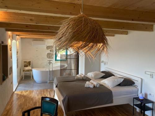 a bedroom with a bed and a bathroom with a tub at Blue Dream in Murvica
