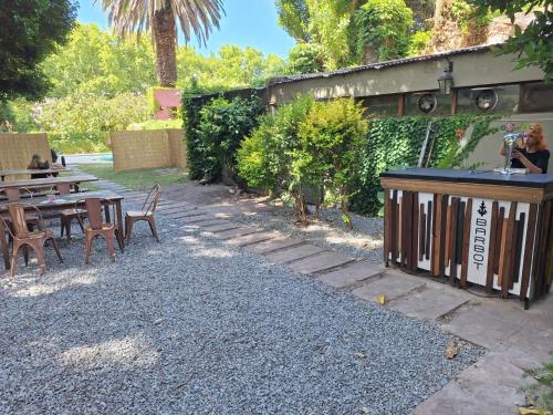 a patio with a bar and tables and chairs at Viajero Colonia Hostel in Colonia del Sacramento