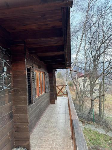an outside view of a building with a porch at Górski domek w Szczyrku in Szczyrk