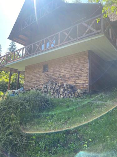 a building with a pile of rocks in the grass at Górski domek w Szczyrku in Szczyrk