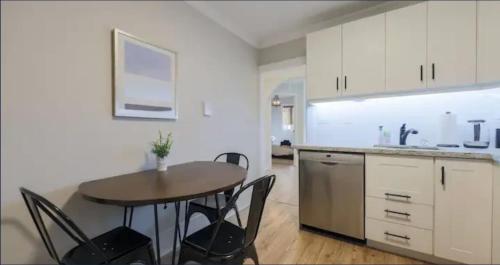 a kitchen with a table and chairs in a room at Casa Queen East - Modern 2BR Suite in Leslieville in Toronto