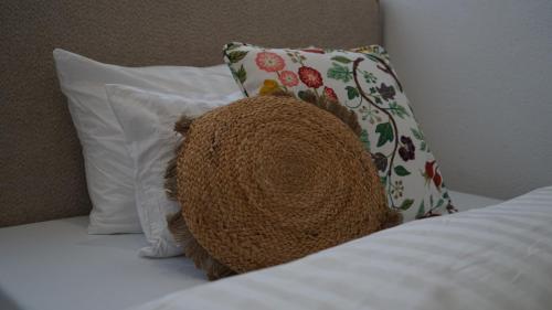 a brown hat sitting on top of a bed with pillows at House of AlAy in Künzelsau