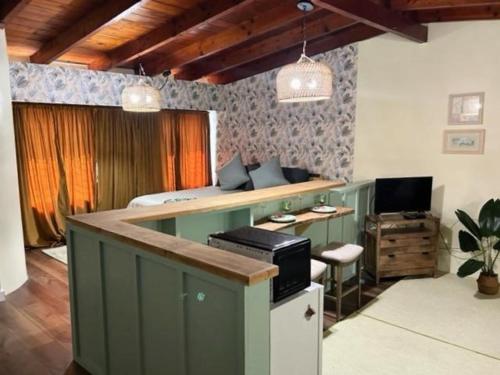 a room with a counter with a desk and a television at Tropical Cottages in Marathon