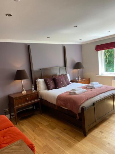 a bedroom with a large bed and two night stands at The Bridge House, Dunbar in Dunbar