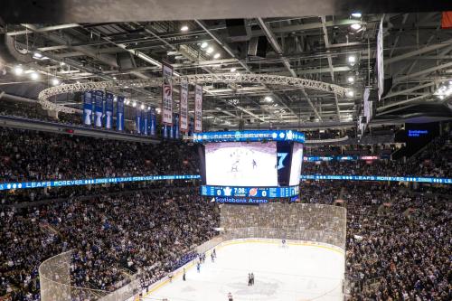 an arena with a crowd of people watching a hockey game at Holiday Inn Toronto International Airport by IHG in Toronto