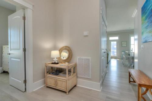 a hallway with a table with a mirror and a lamp at Aloweha in Oak Island