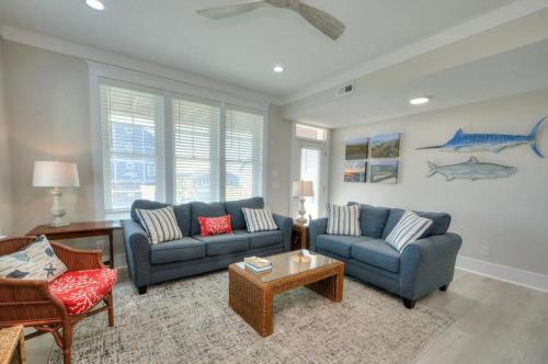 a living room with two couches and a table at Aloweha in Oak Island