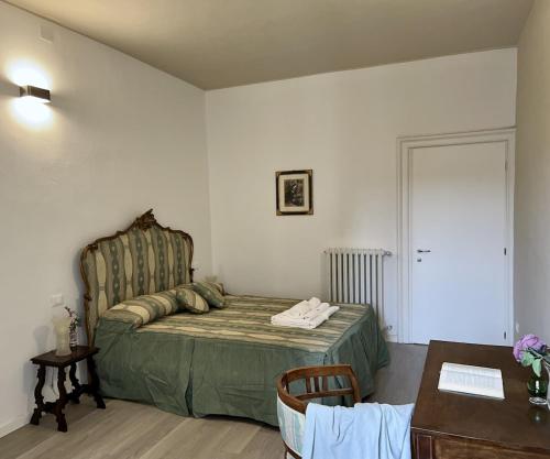 a bedroom with a bed and a table and a desk at Inn Borromeo - Pavia City - by HOST4U in Pavia