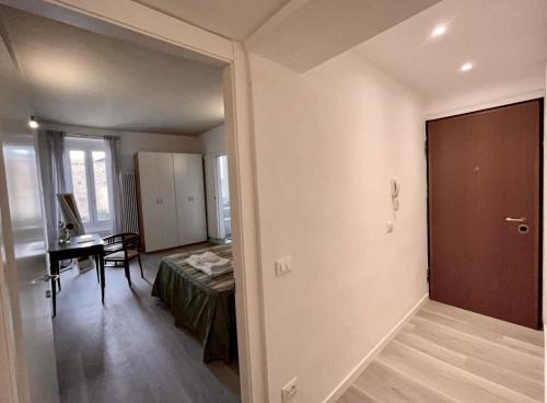 a bedroom with a bed and a desk in a room at Inn Borromeo - Pavia City - by HOST4U in Pavia